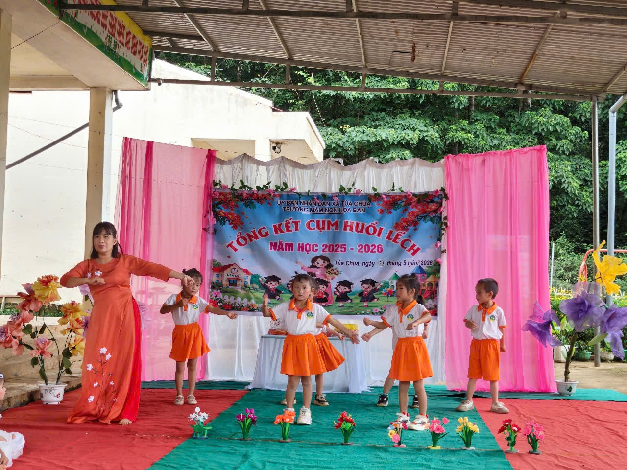 'A group of children dancing on a stage

Description automatically generated'
